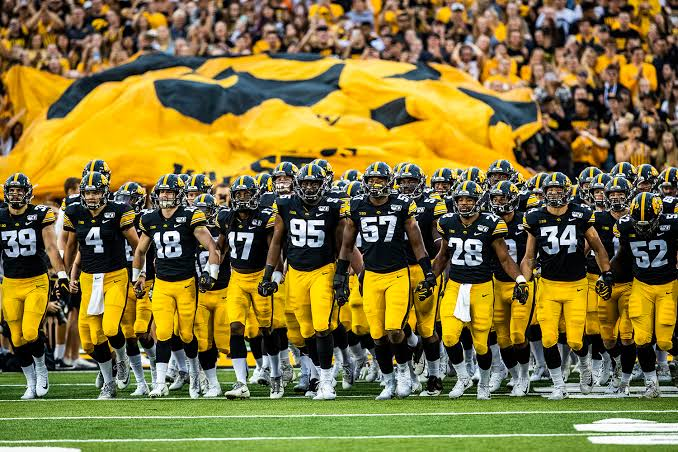 Iowa Hawkeyes team lined up together showing unity and team spirit in black and gold