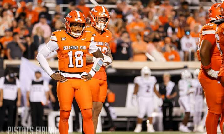 Oklahoma State Cowboys players in orange jerseys celebrating on the field