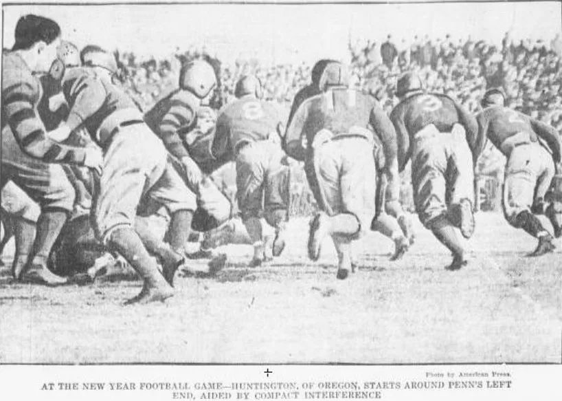 Newspaper photograph of early football action, printed beneath a caption reading that Huntington of Oregon starts around Penn's left end at the New Year football game