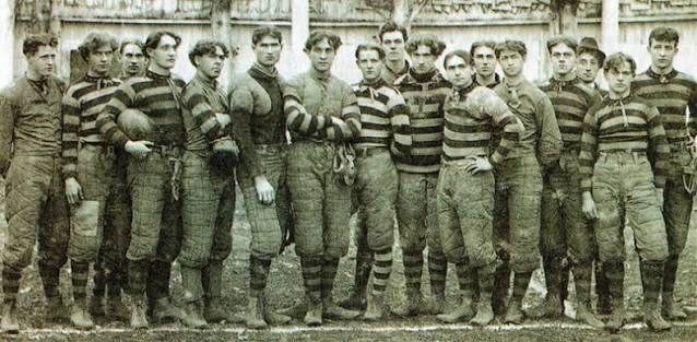 Sepia photograph of an early Oregon squad standing shoulder to shoulder in striped jerseys and padded trousers